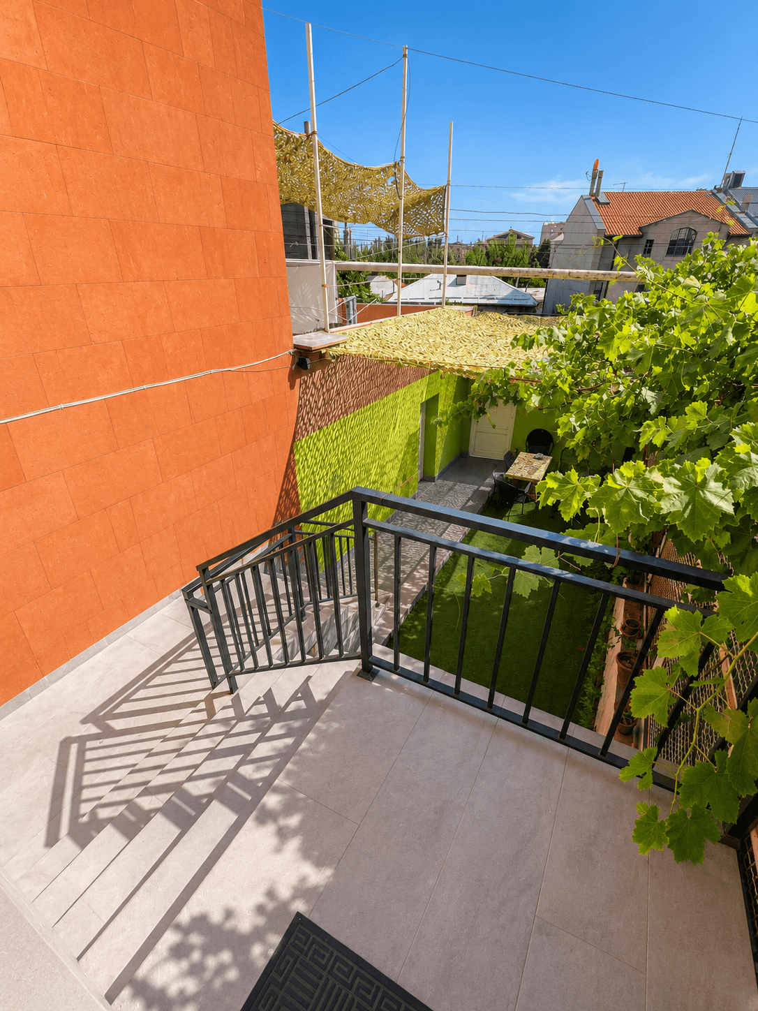 Sunny green terrace at Dreamers Hostel